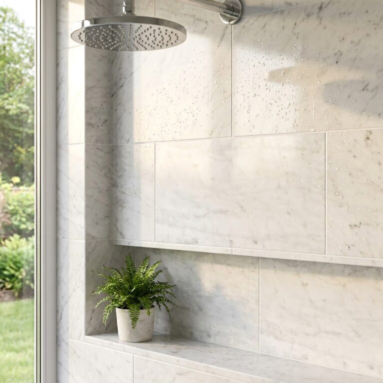 Shower with Bianco Carrara 12x24 polished marble tile, a recessed shelf, and a fern beside a window