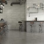 Industrial cafe with Midtown 12x24 Alumina and Graphite concrete-look porcelain tile on the walls and floor
