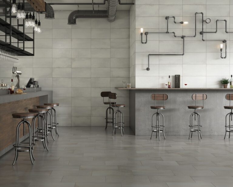 Industrial cafe with Midtown 12x24 Alumina and Graphite concrete-look porcelain tile on the walls and floor