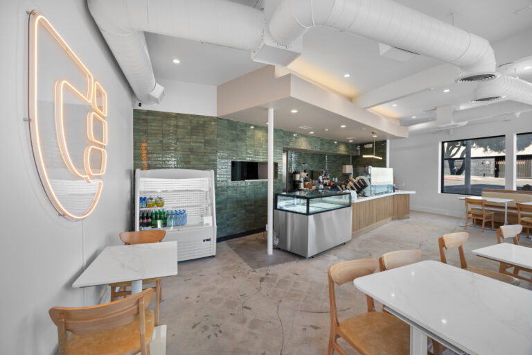 Cafe interior with a green Posh 2-3/8x9-7/8 brick wall tile behind the counter