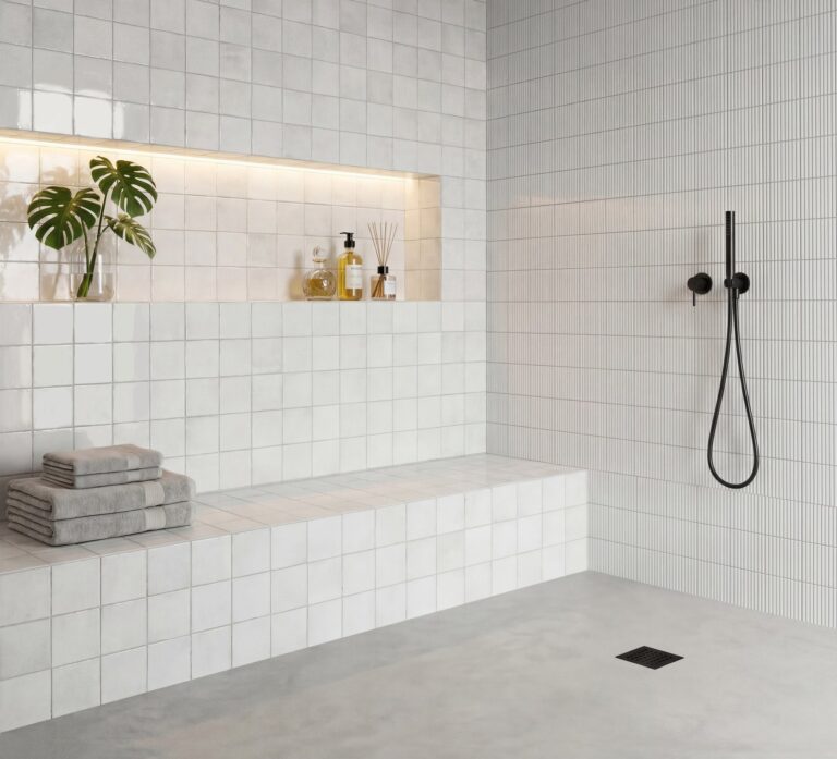Walk-in shower with Drift 6x6 white porcelain and 3D Ripple tile, a tiled bench and a lit niche