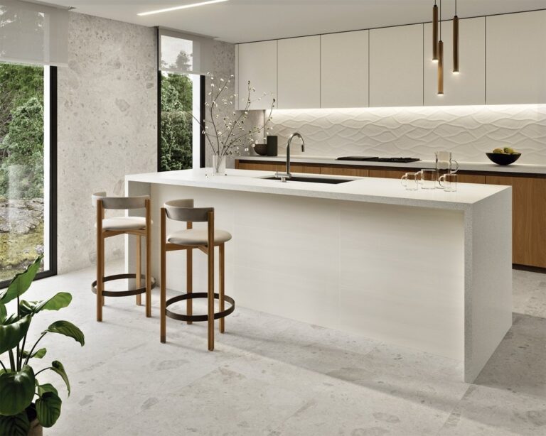Modern white kitchen with a Galerie Sylva 3D white wall tile backsplash, waterfall island and wood bar stools